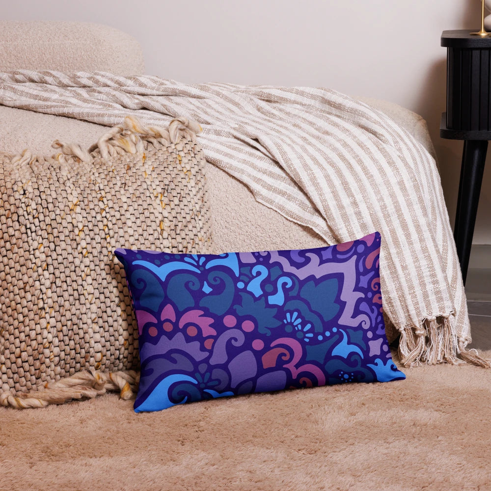 Midnight Berry throw pillow featuring deep, rich colors and elegant, swirly floral-like patterns, resting next to a living room couch.